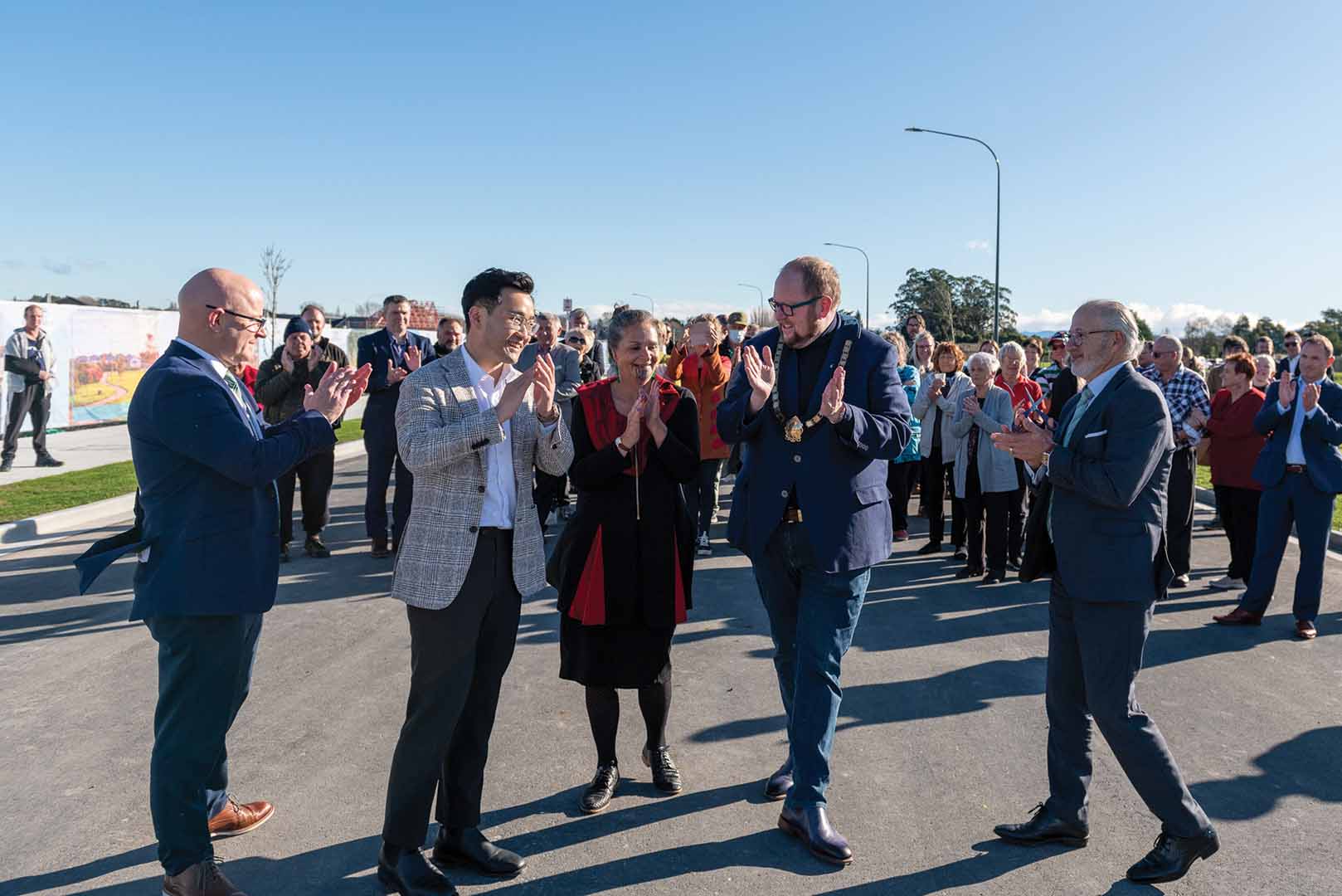 large group of people clapping at the opening of Silverstream Boulevard