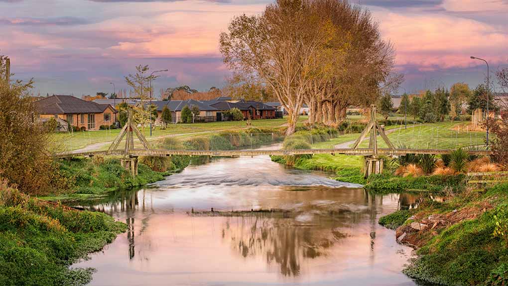 Butcher's Bridge over the the river at sunset looking towards Silverstream Subdivision