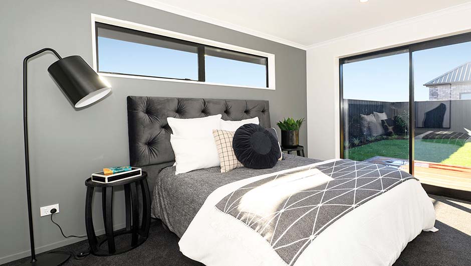 modern bedroom with queen bed and black and white decor