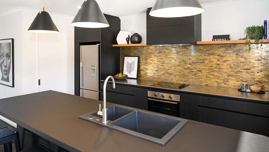 black themed kitchen with brown tile splash back