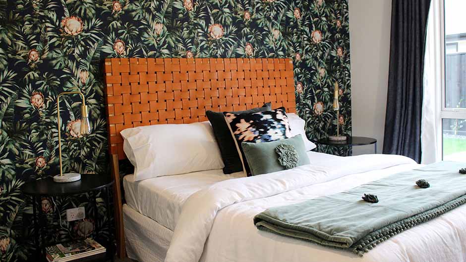 king size bed with floral feature wallpaper
