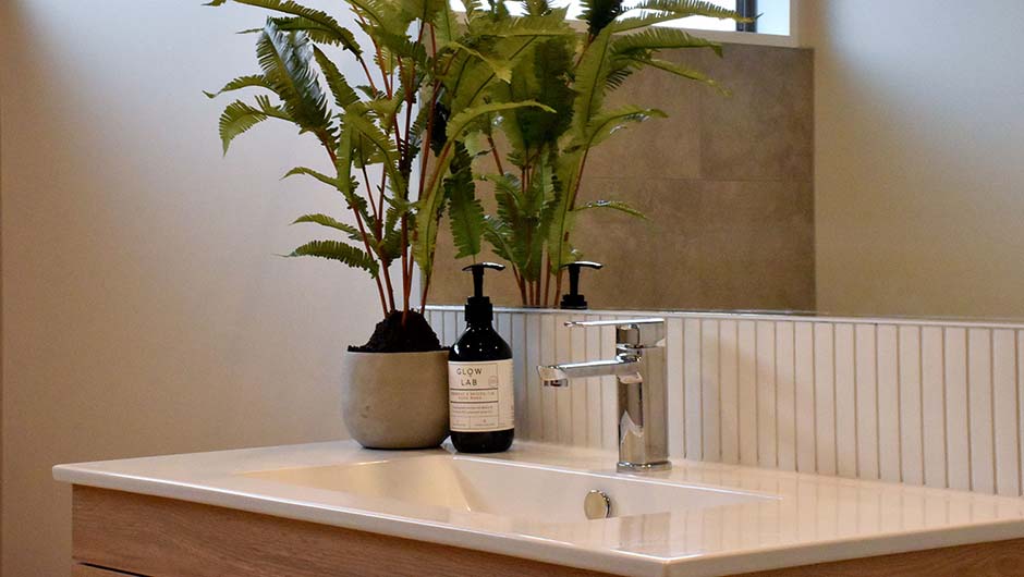 white bathroom vanity with fake plant