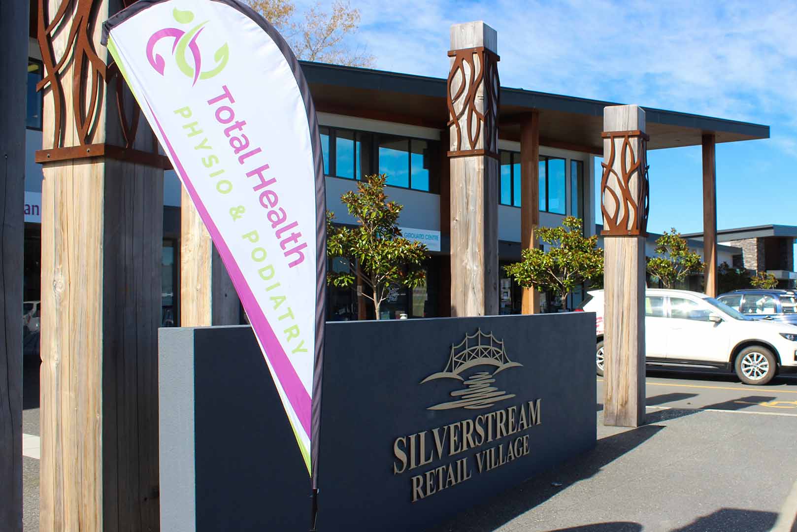 a total health physio & podiatry flat sitting beside the main Silverstream Retail Village sign