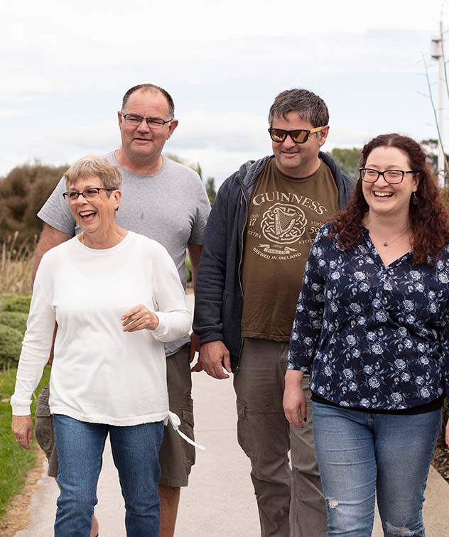 four friends talking while walking outdoors