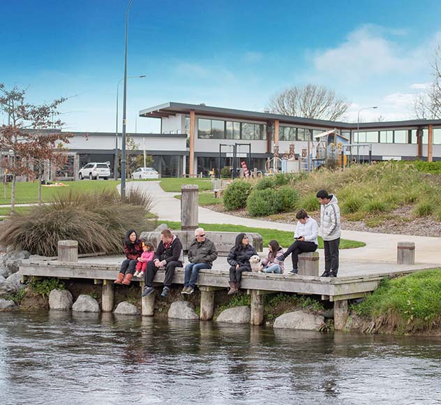 people sit on a jetty chatting